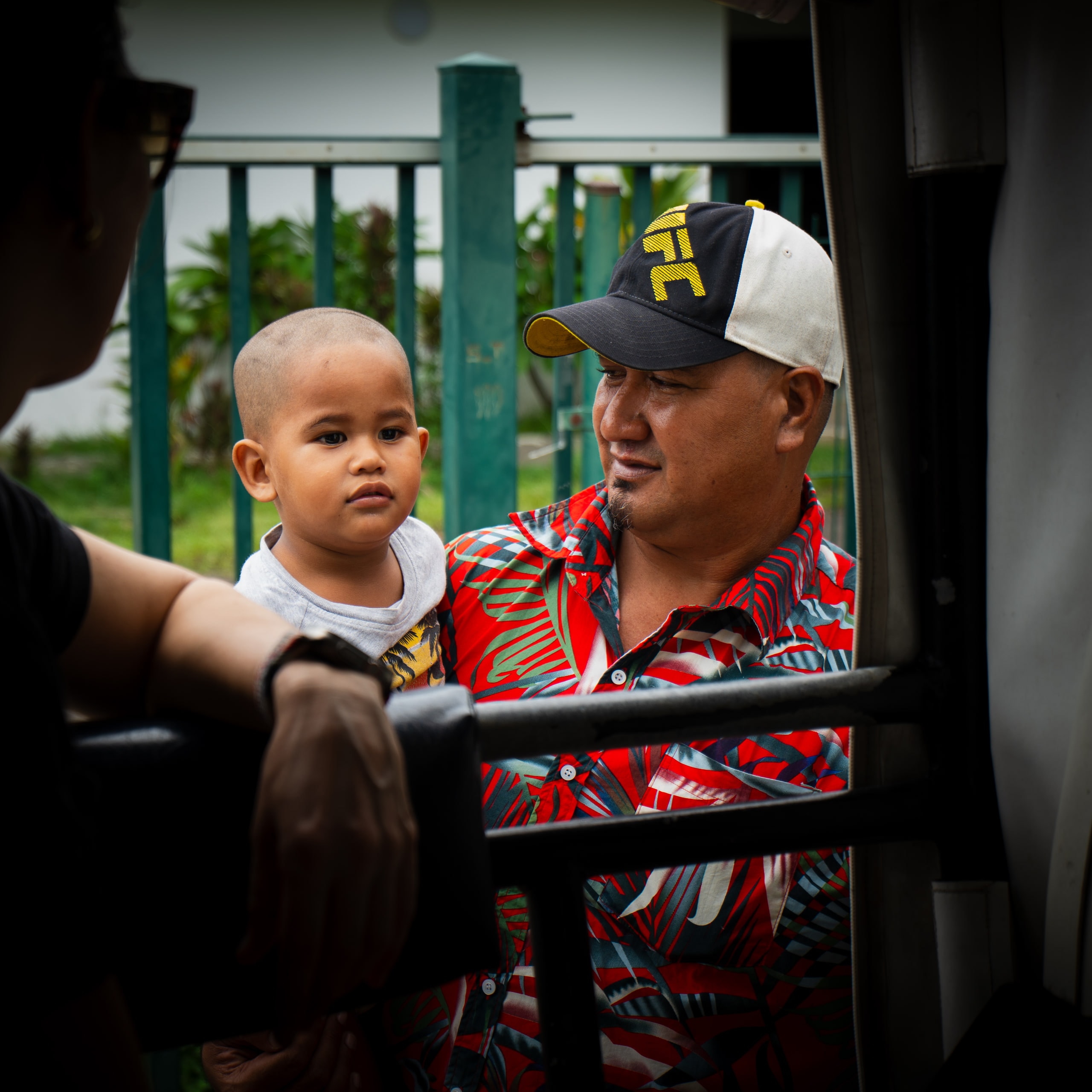 A man holding a small child aboard a boat