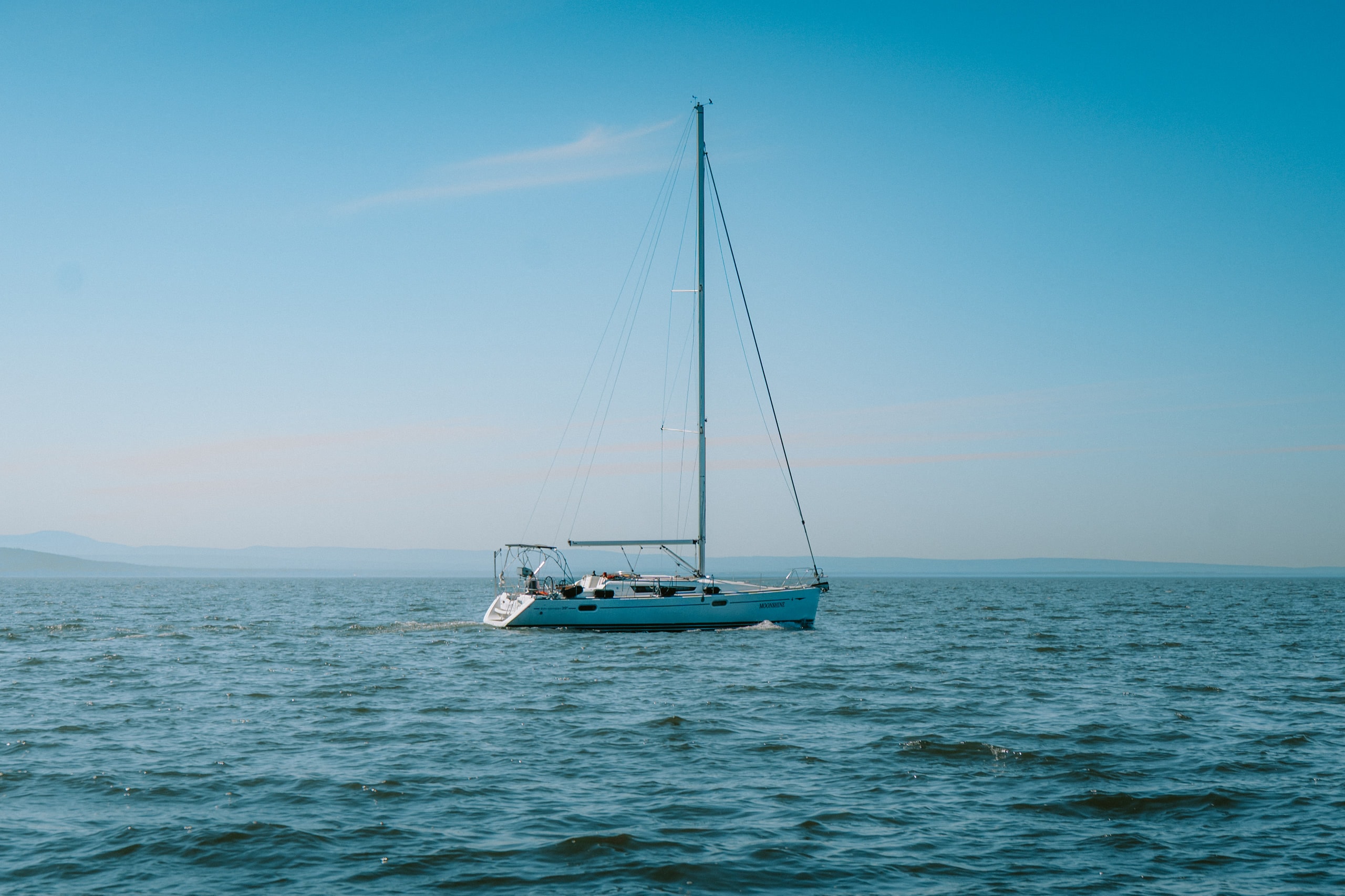 A sailboat at anchor on open water