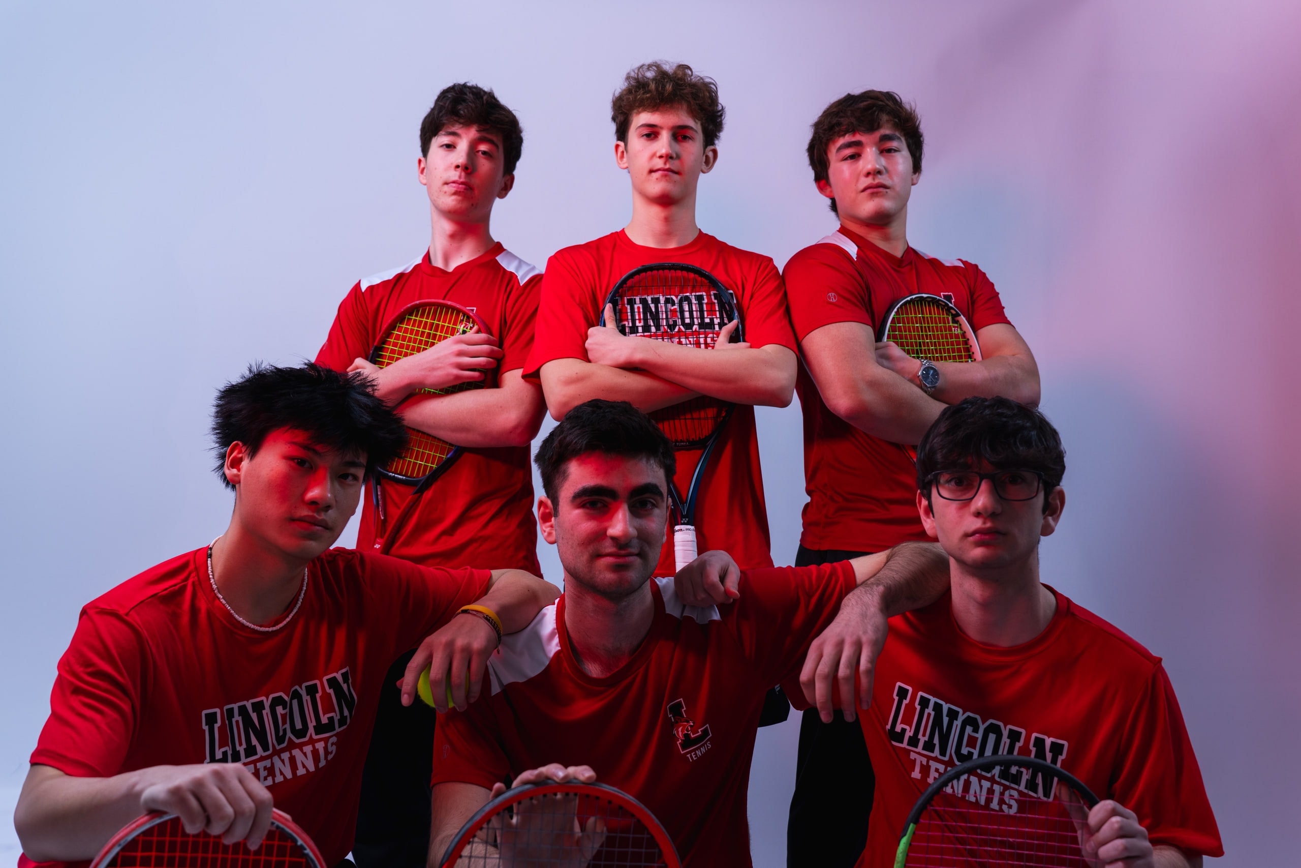 Six members of the boys tennis team grouped for a team portrait