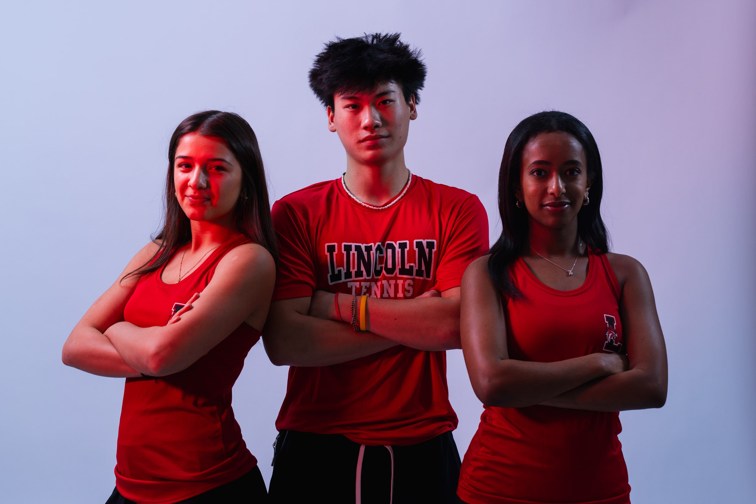 Three players standing together in team shirts