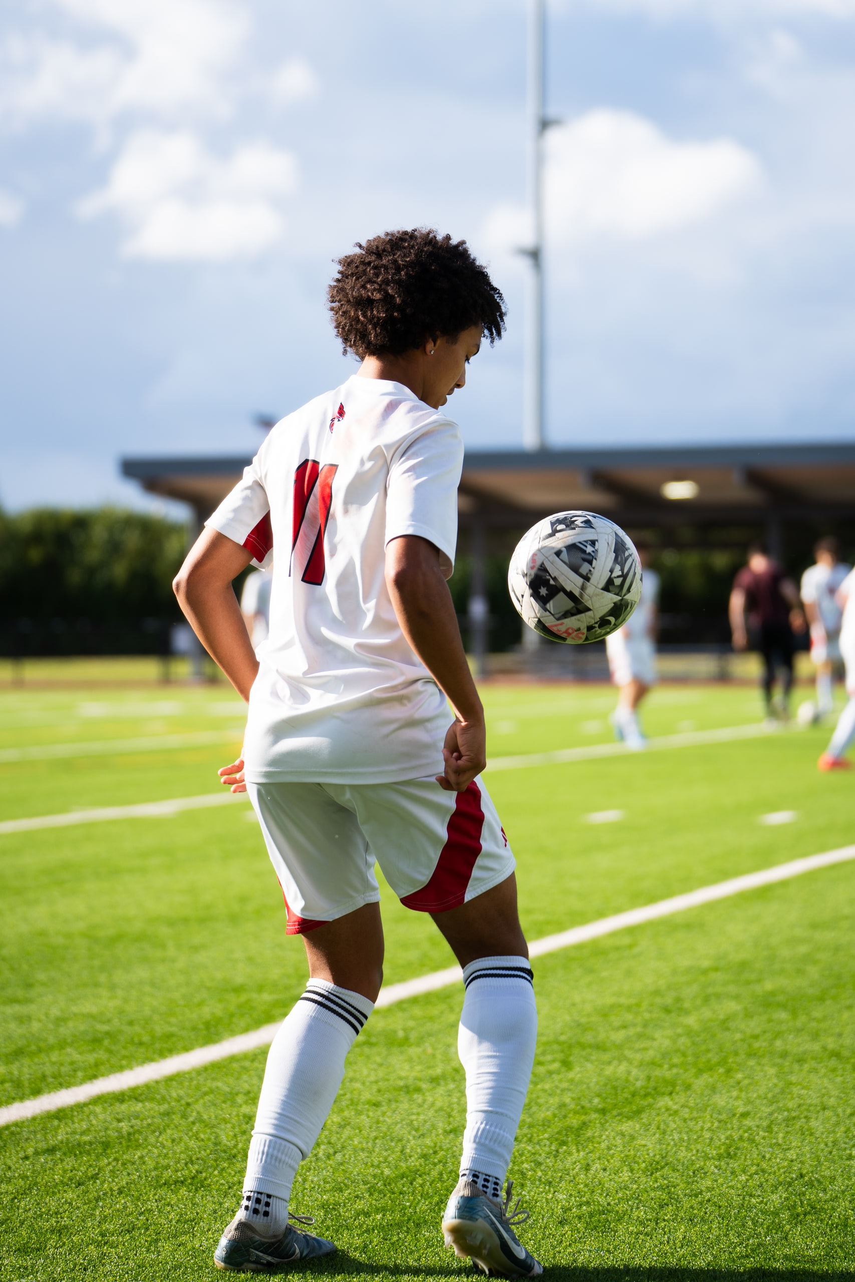 A player shielding the ball at his feet