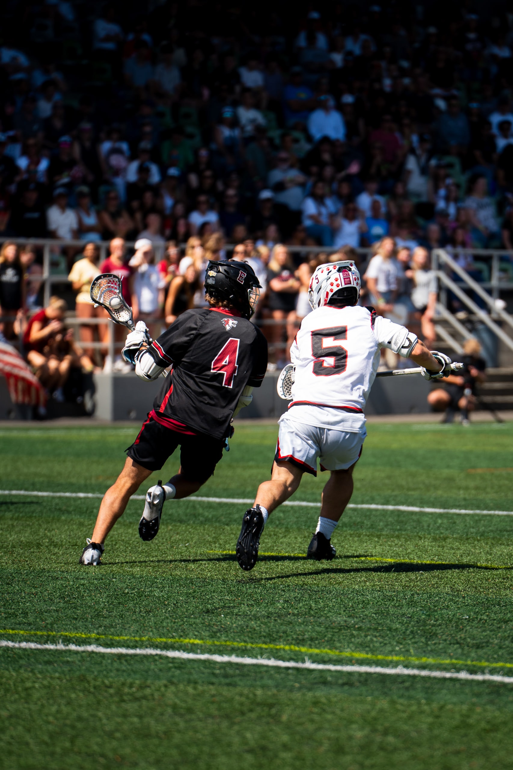 Two players running side by side up the field