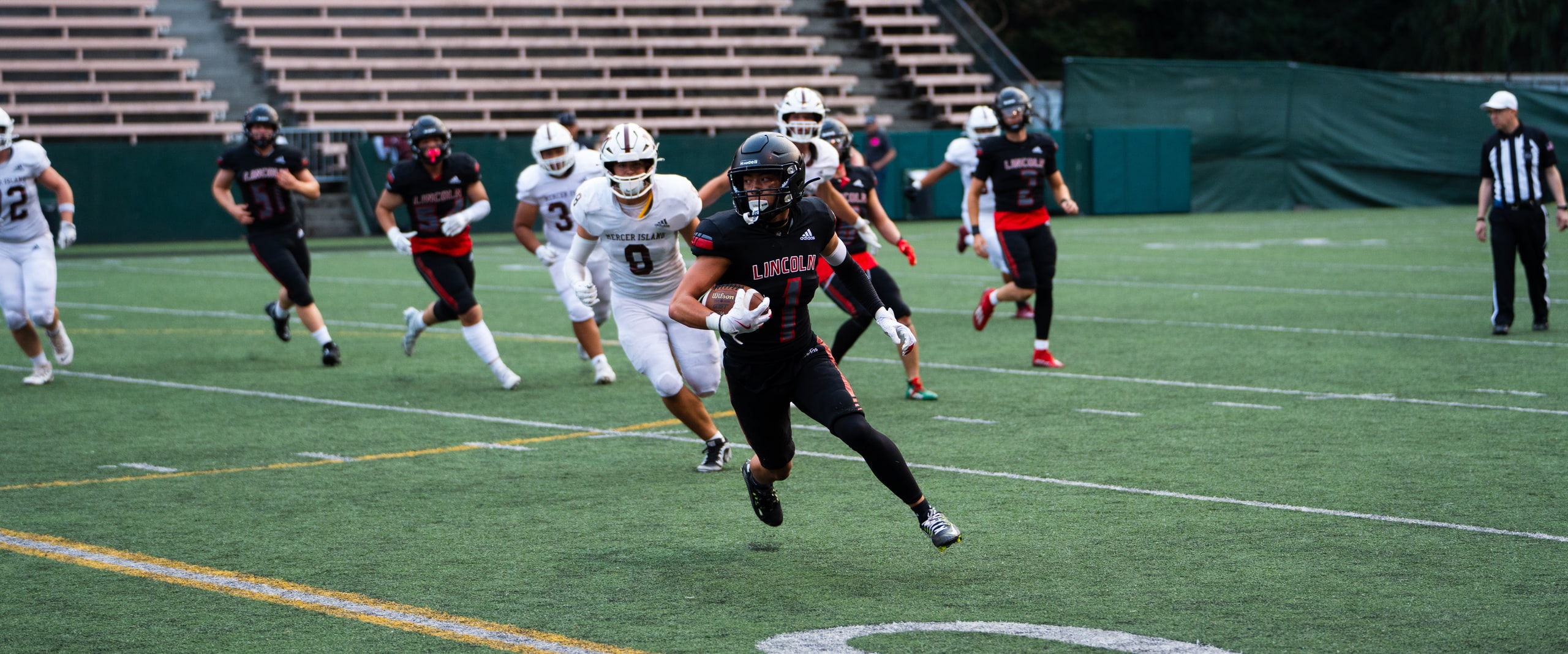A ball carrier turning upfield through traffic