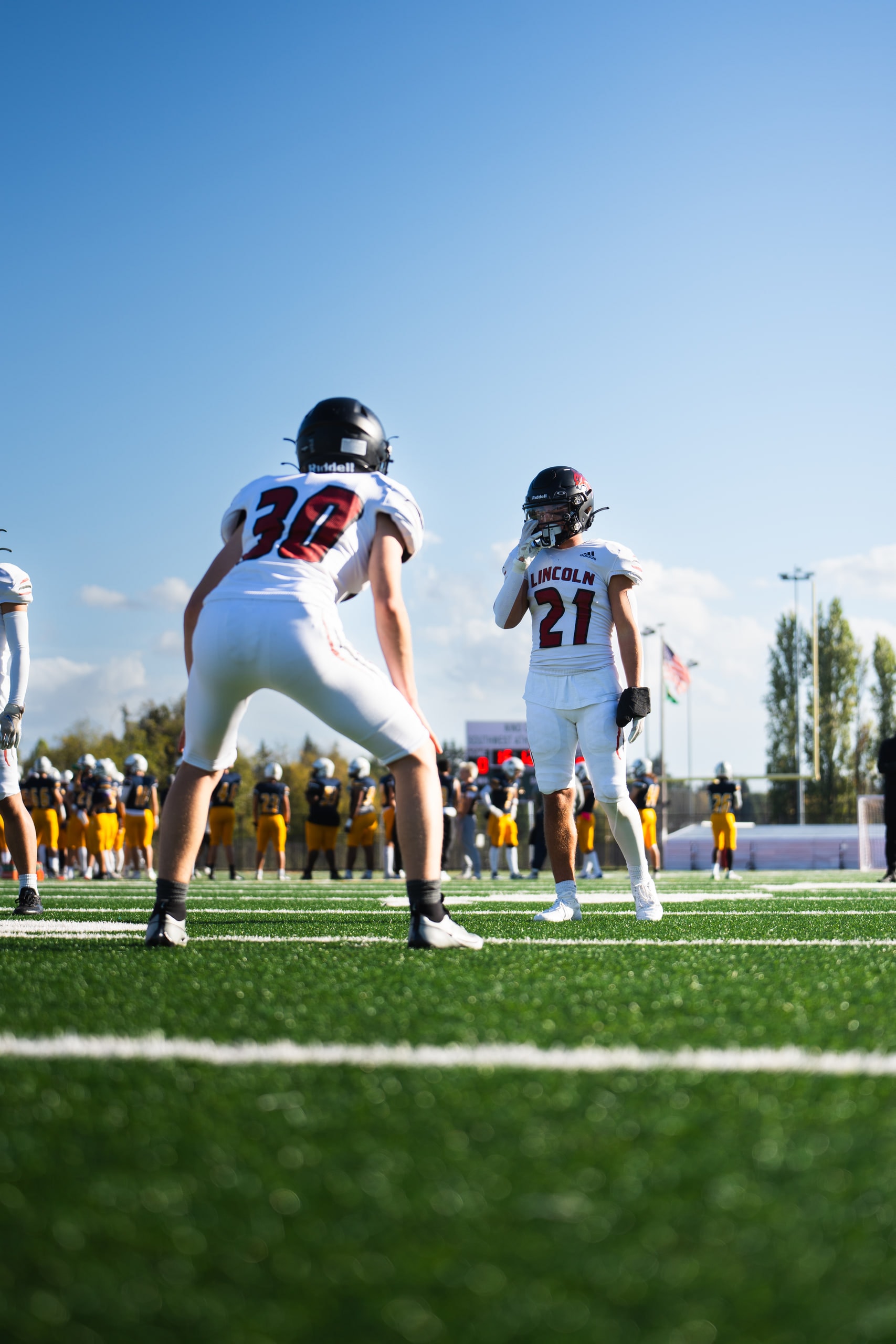 Two players seen from behind walking out onto the field