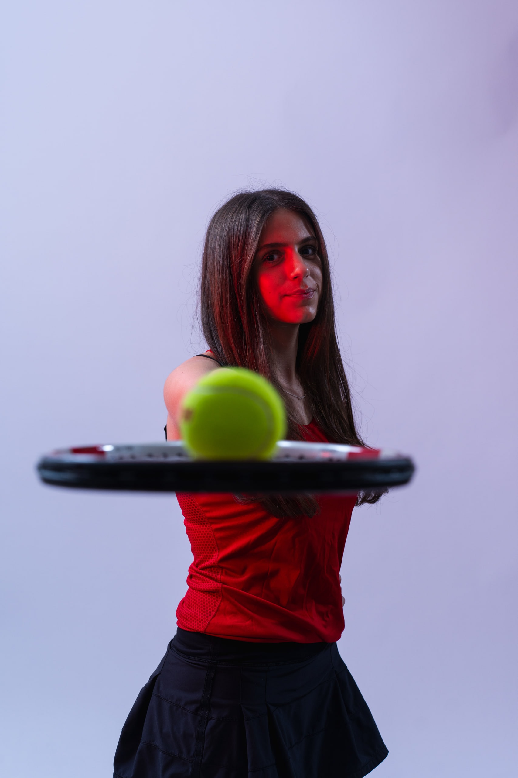 A player balancing a ball on her strings