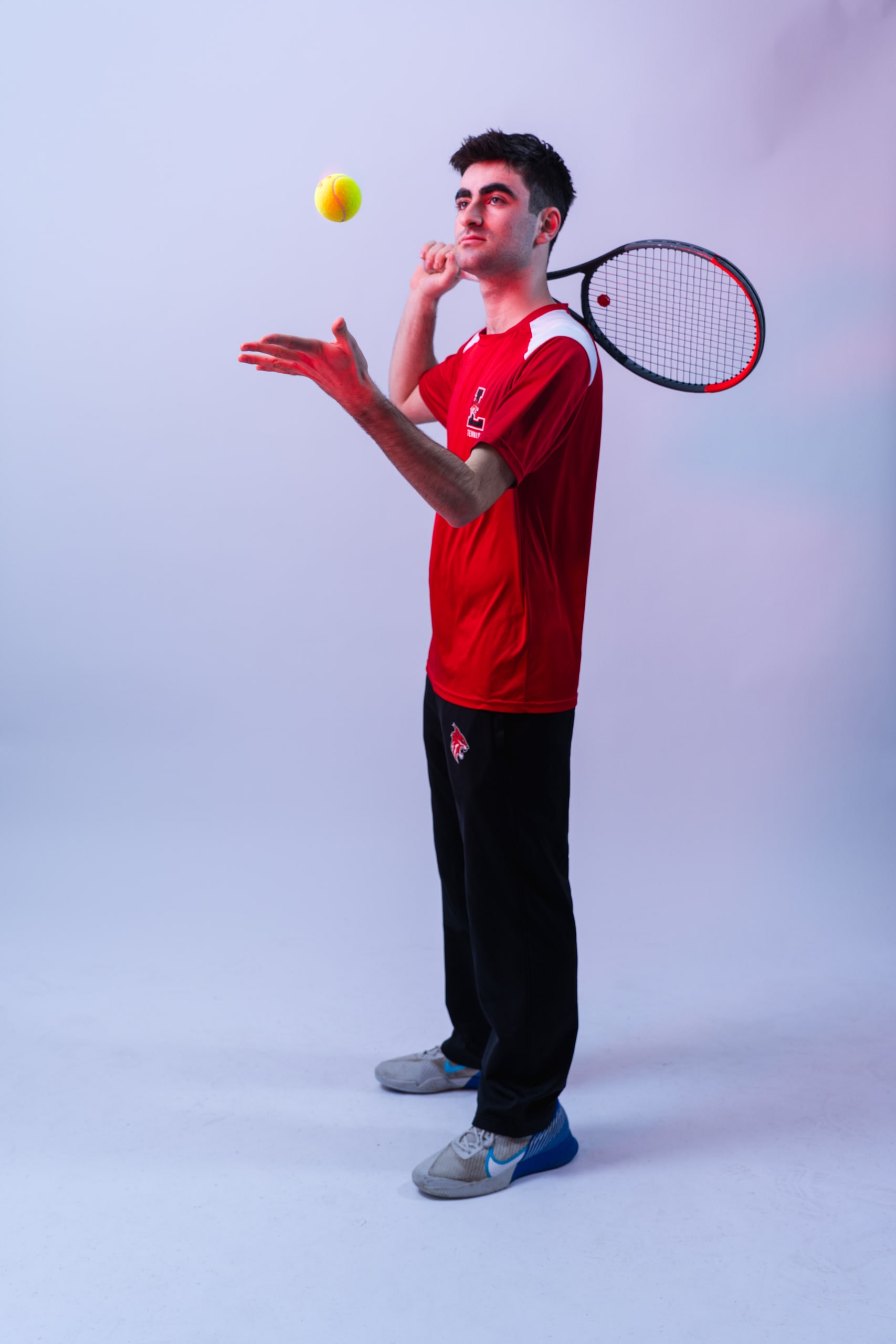 A player tossing a ball above his racket
