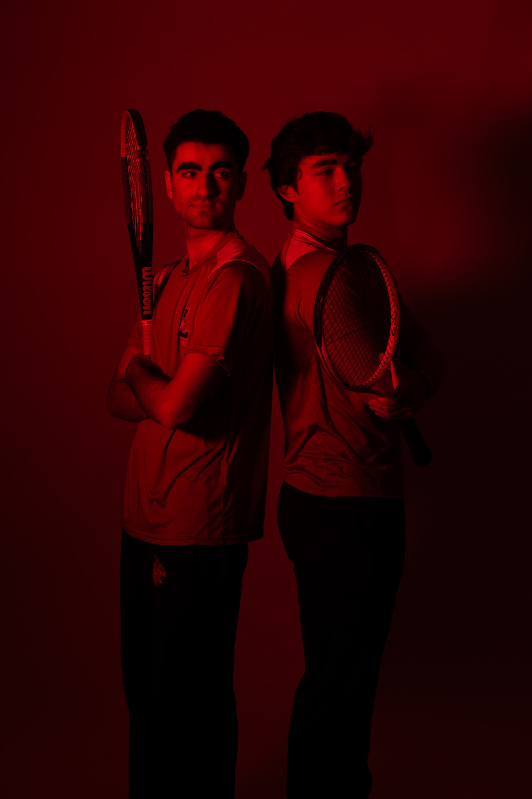 Two players standing together lit in red